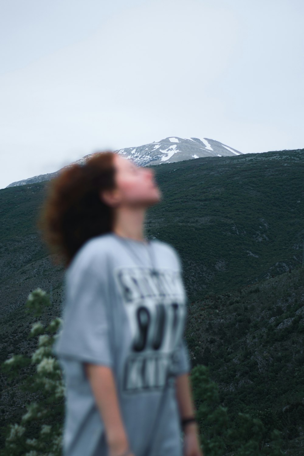 a person standing in front of a mountain