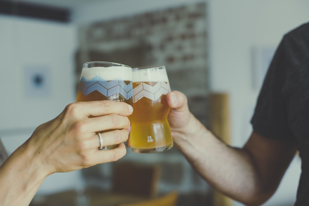 a couple of people that are holding some glasses