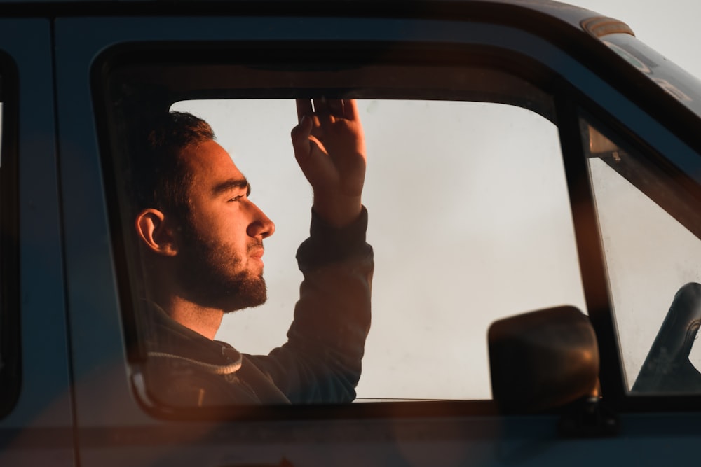 a man sitting in the drivers seat of a car