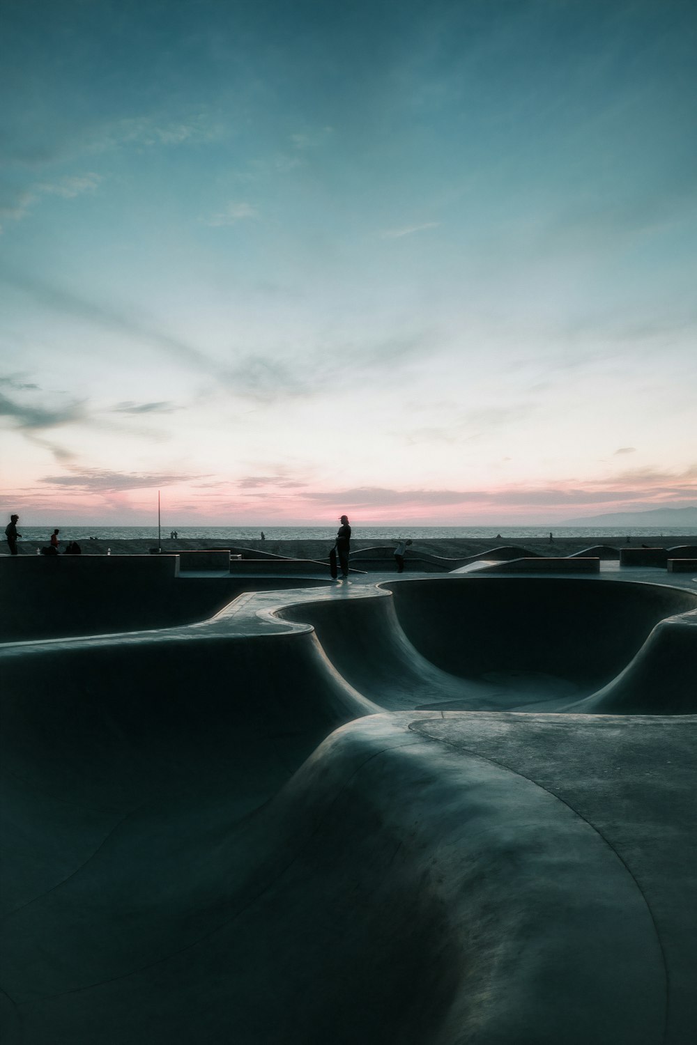 a person standing on top of a skateboard ramp