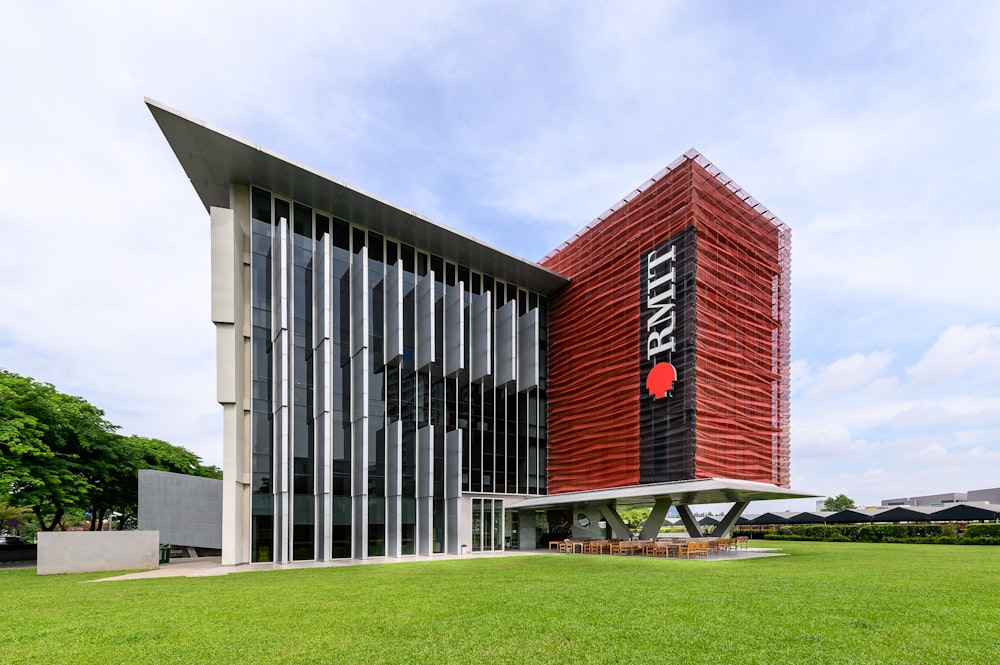 a tall building with a red and black sign on it's side