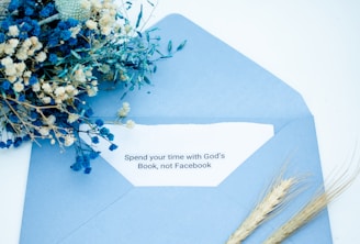 An inviting care package open to reveal Bible study materials, art supplies, and a handwritten note.