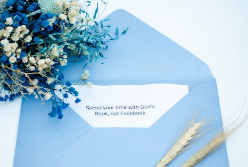 An inviting care package open to reveal Bible study materials, art supplies, and a handwritten note.