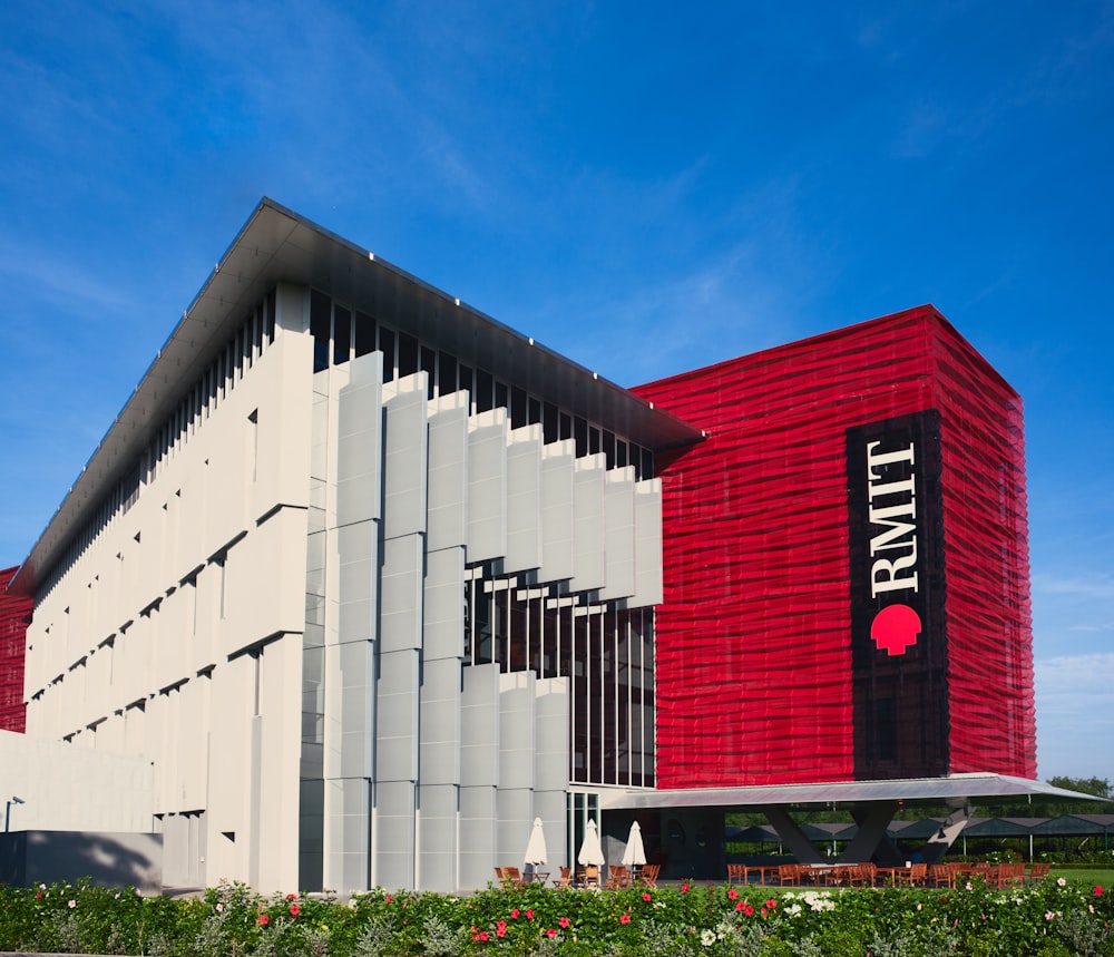 a large building with a red and white facade