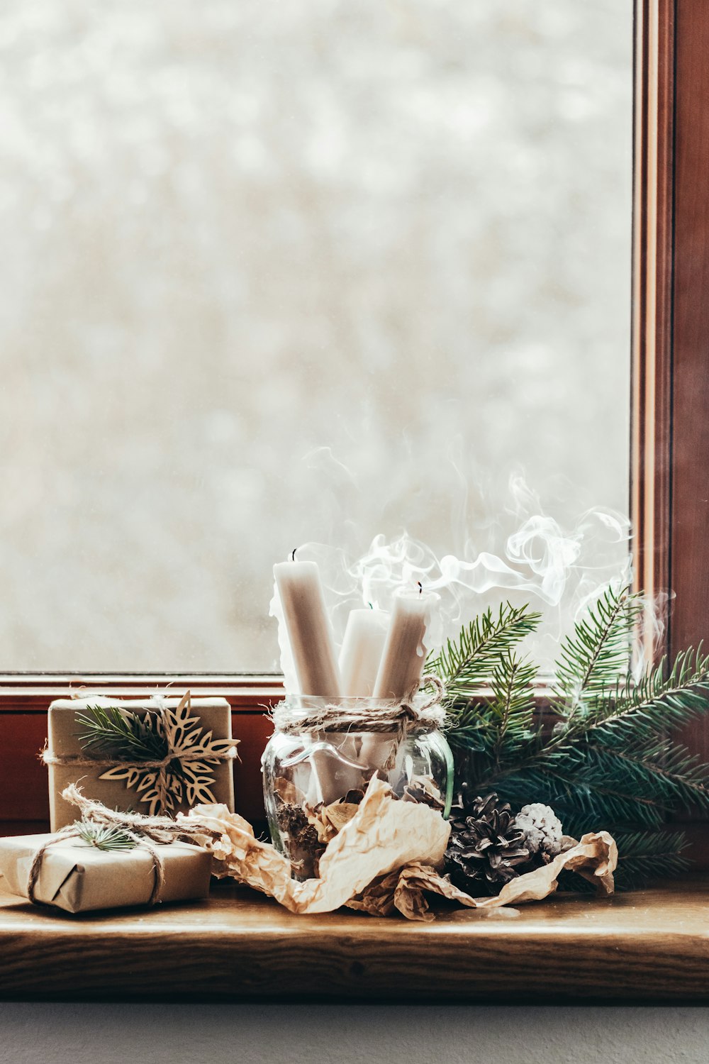 a window sill with a glass jar filled with candles