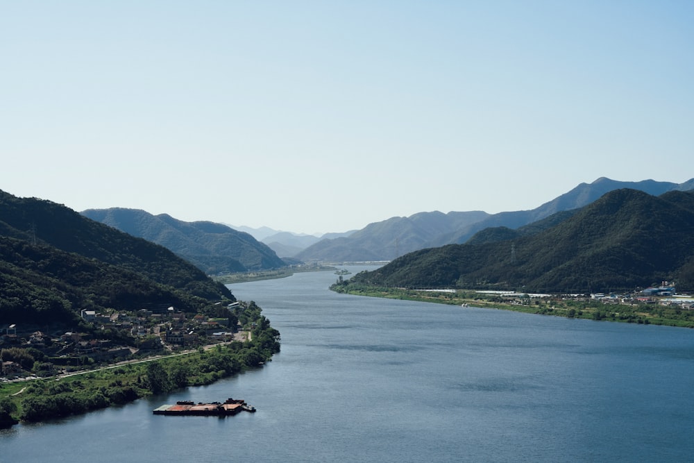 a body of water with a mountain in the background