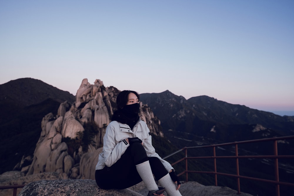 a person standing in front of a mountain