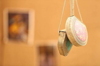 a close up of a pair of shoes hanging from a chain