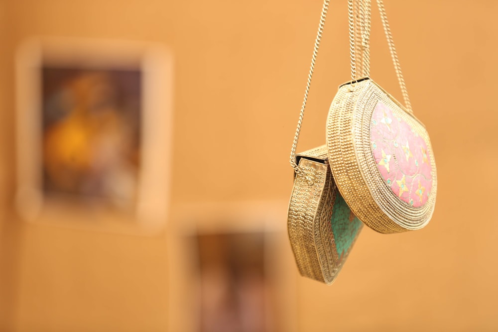 a close up of a pair of shoes hanging from a chain