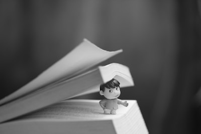 a small figurine sitting on top of a book