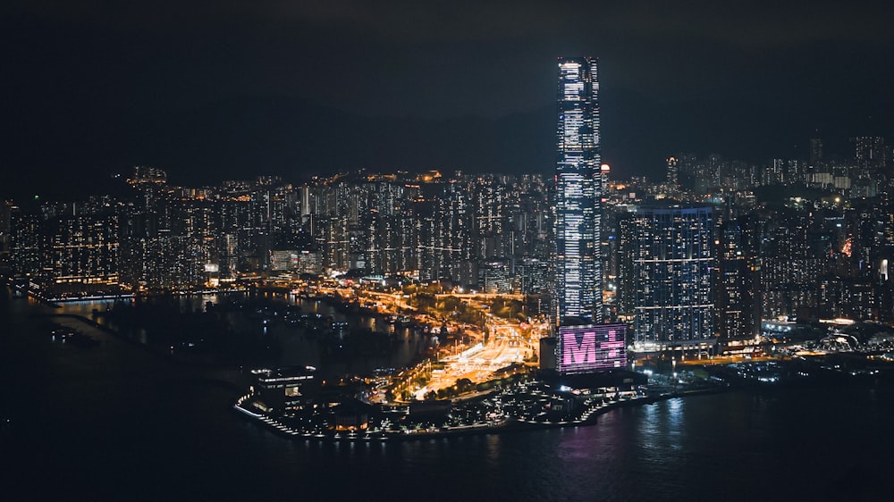 a very tall building towering over a city at night