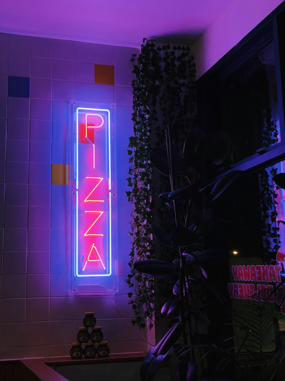 a neon sign that reads pink on a wall