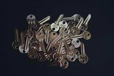 A set of shiny keys held in a locksmith’s hand ready to be duplicated