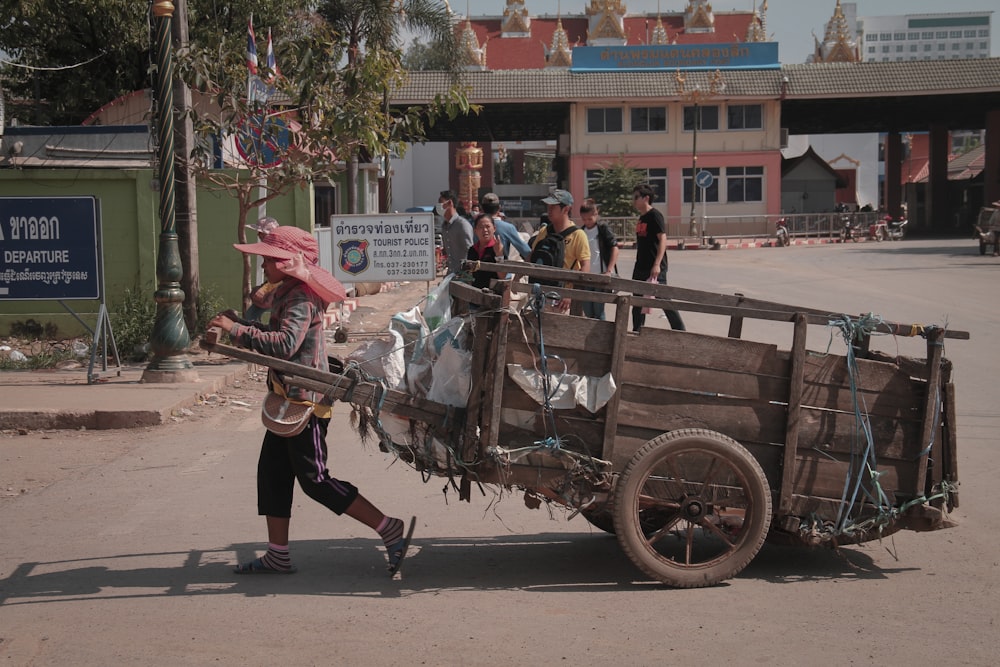 a person pushing a cart with a bunch of items on it