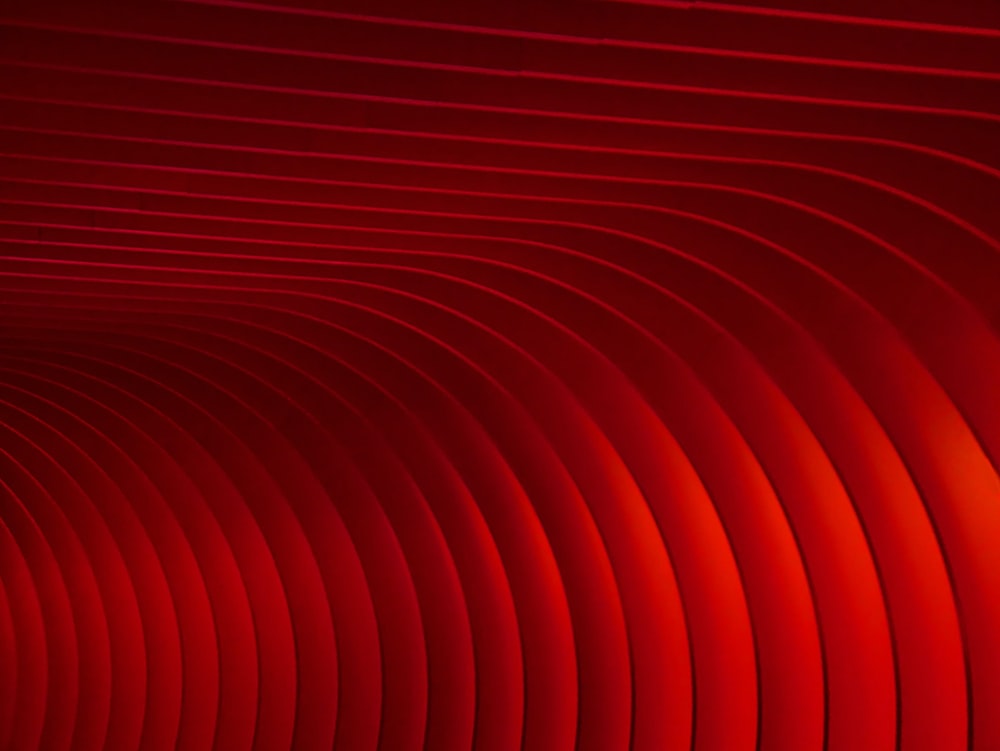 a red abstract background with wavy lines