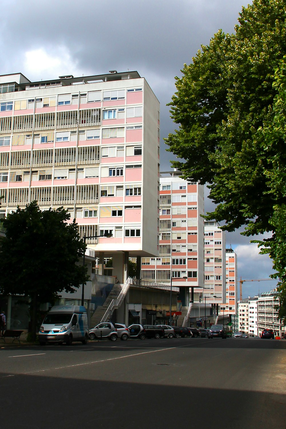 a city street with tall buildings and trees