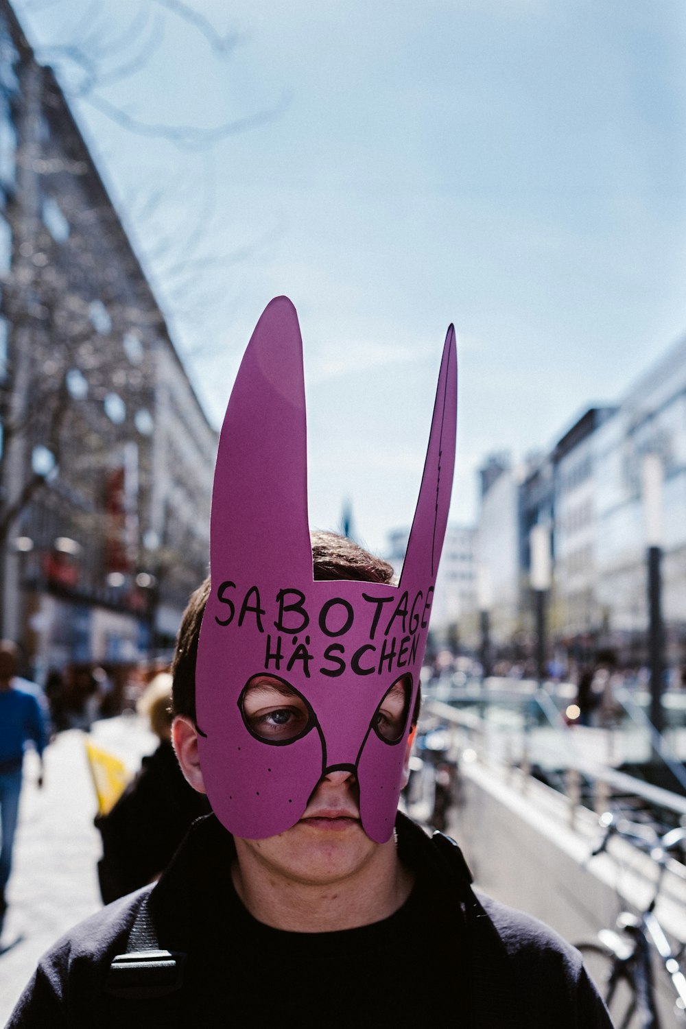 a man wearing a pink mask with writing on it