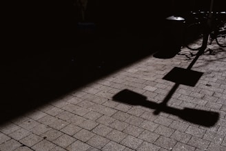 a shadow of a street sign on a sidewalk