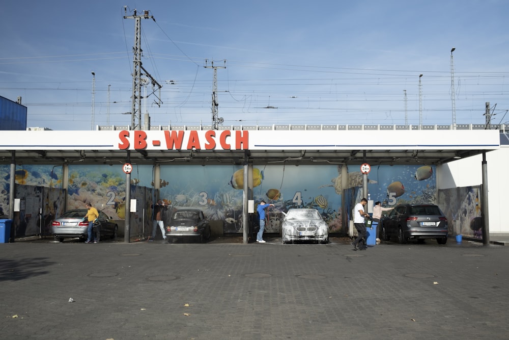 a group of people standing in front of a car wash