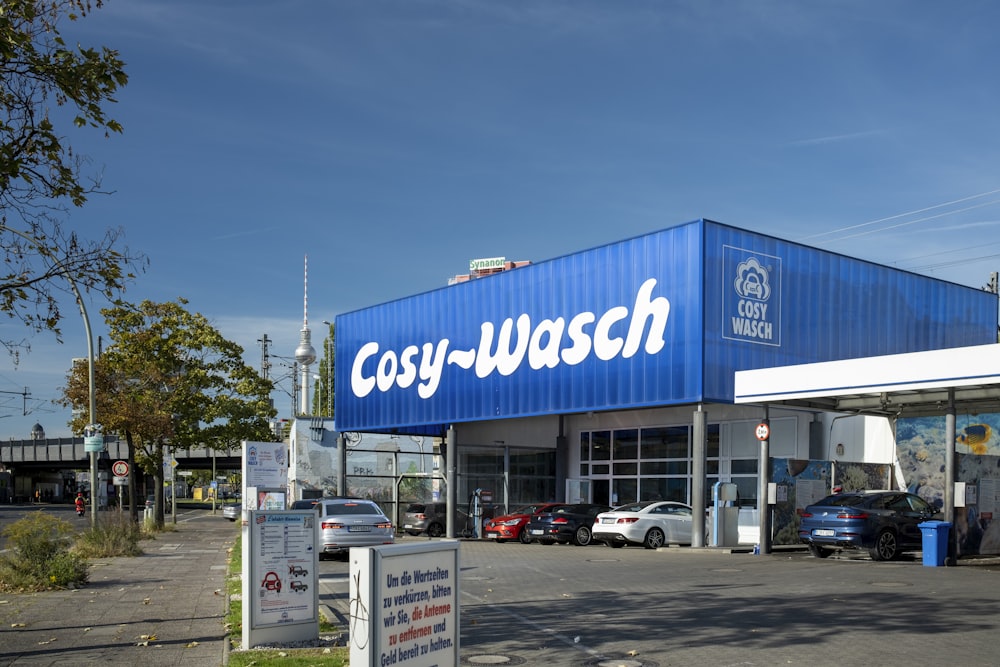 a gas station with cars parked in front of it