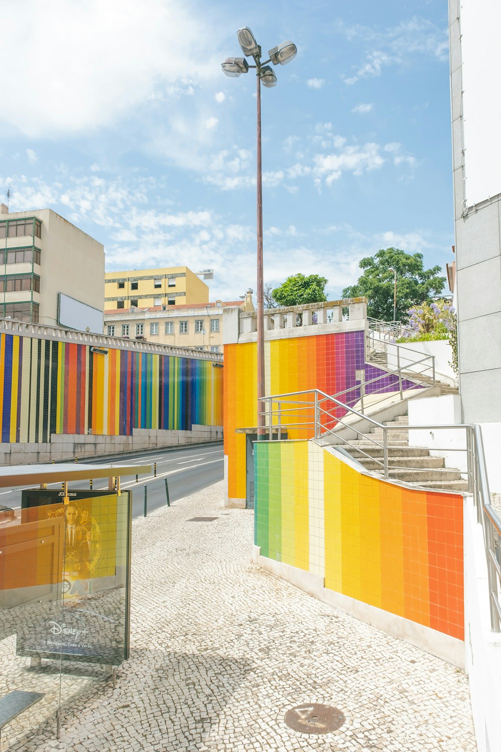 a row of multicolored buildings next to a street