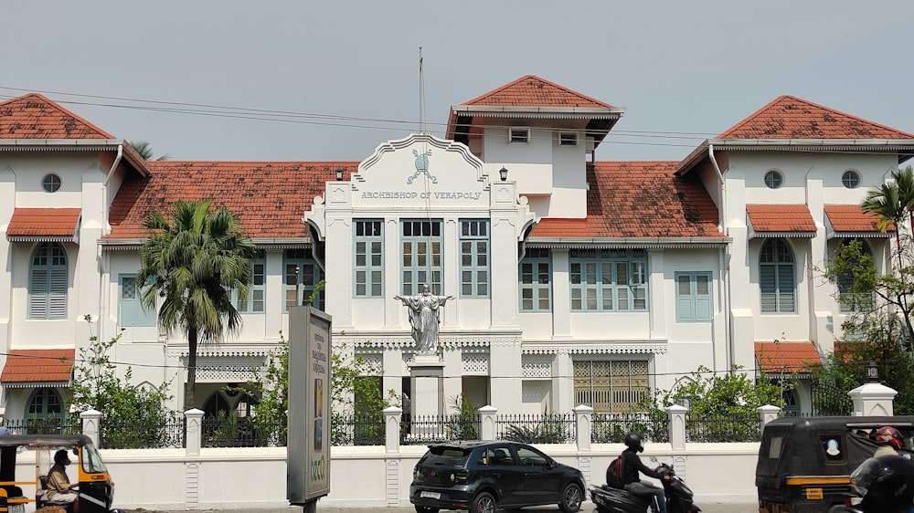 a large white building with a clock on the front of it