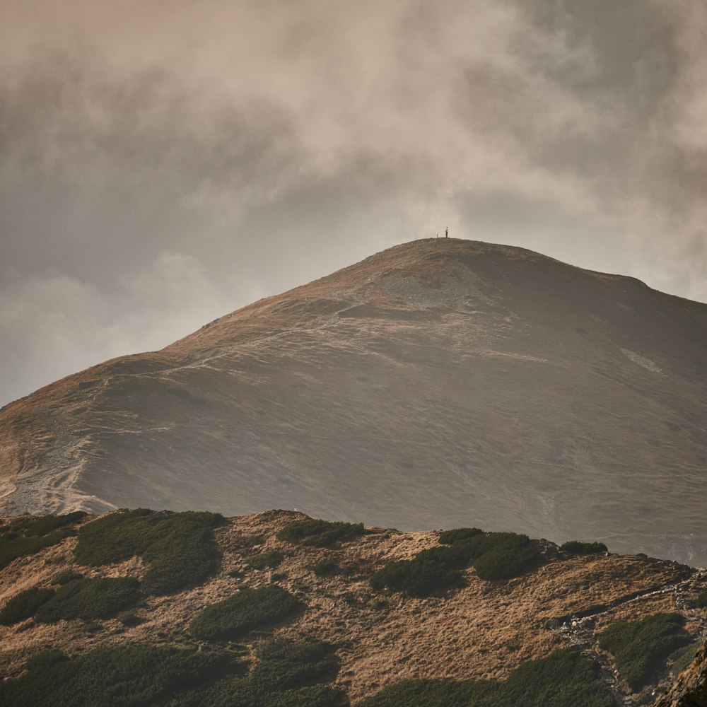 a hill that has a person on top of it