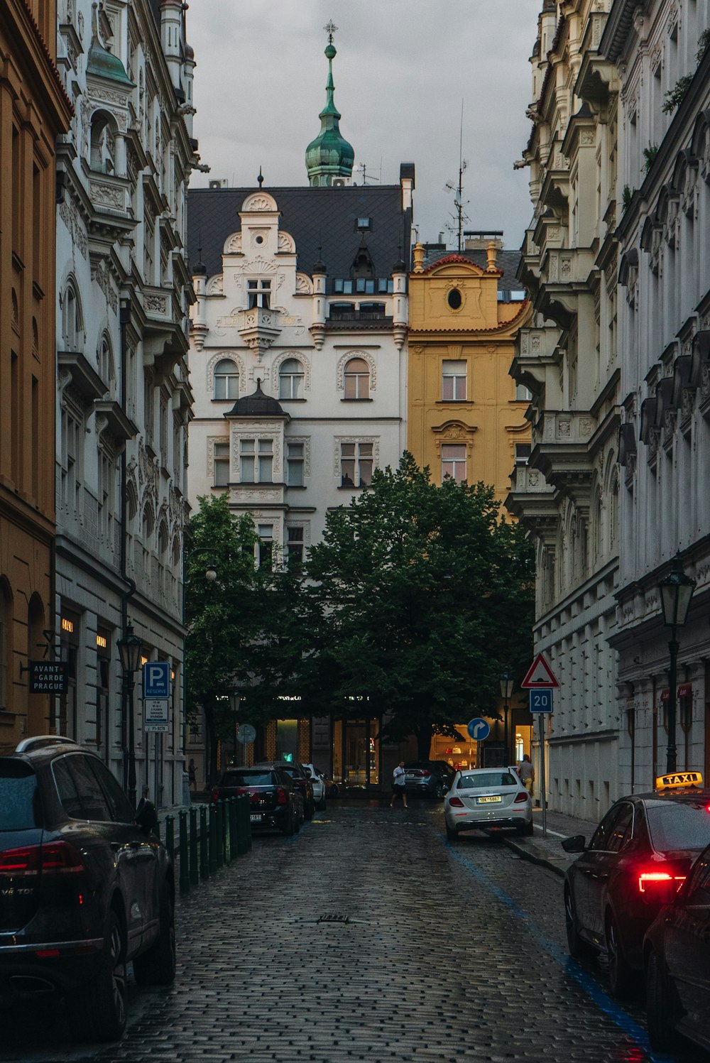 a cobblestone street lined with tall buildings