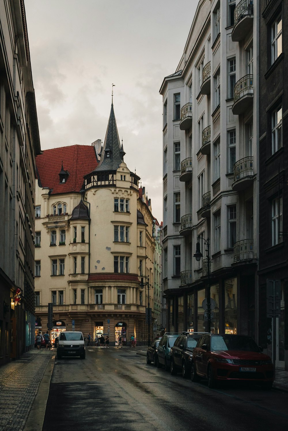 a city street lined with tall buildings and parked cars