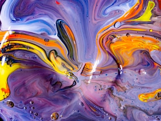 Vibrant acrylic pouring painting with swirling colors blending seamlessly on canvas.