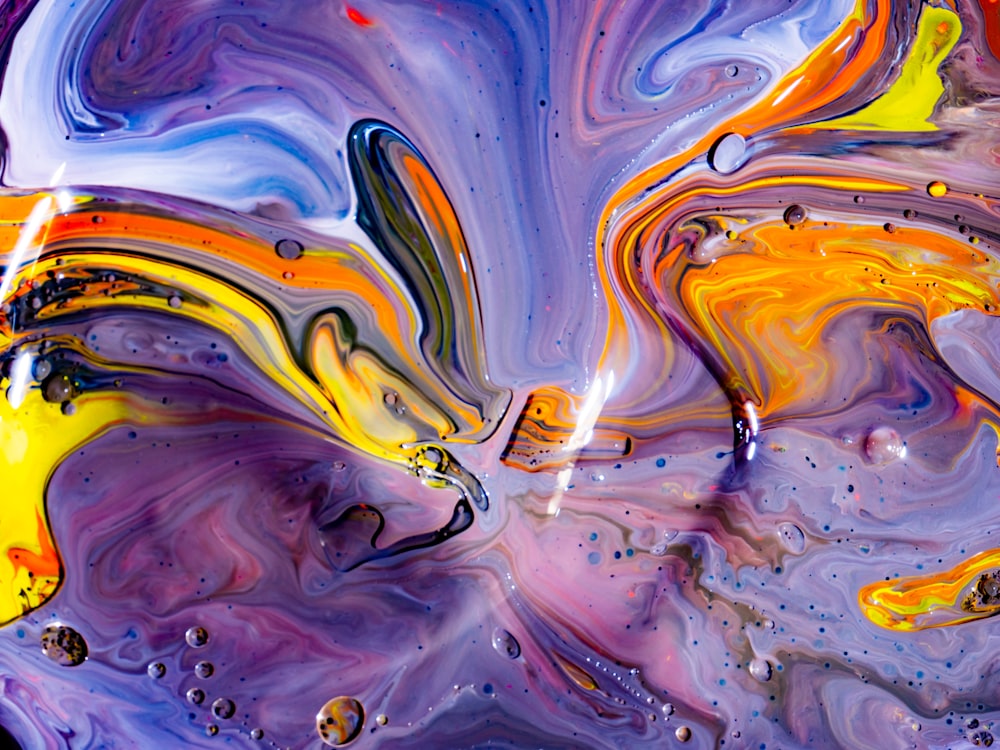 an abstract painting of yellow, blue, and purple colors