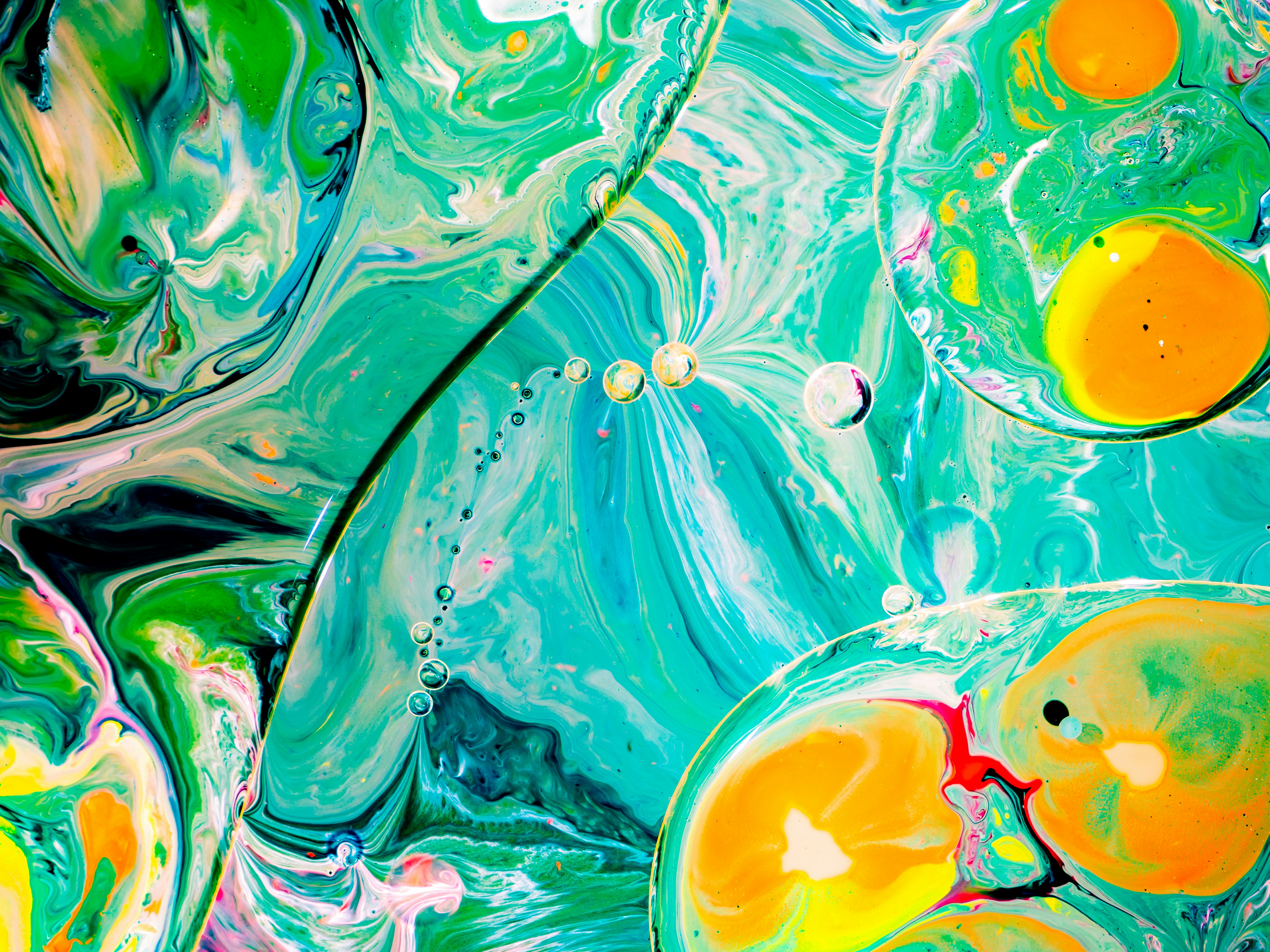 a close up of an abstract painting of blue, yellow, and green
