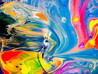 A vibrant hoodie featuring a bold, hand-painted abstract design blending bright colors and dynamic shapes.