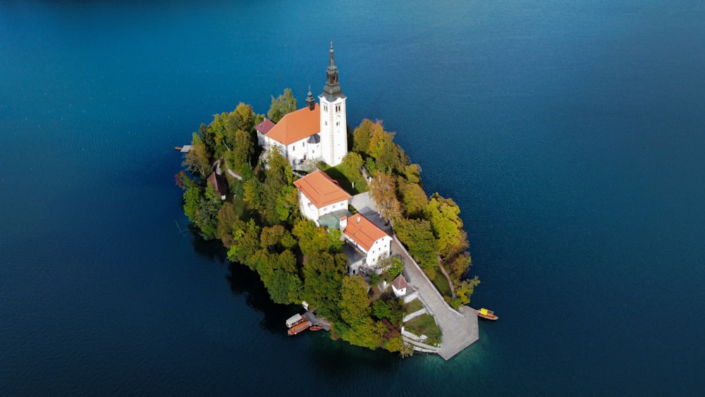 an island in the middle of a lake with a church on it