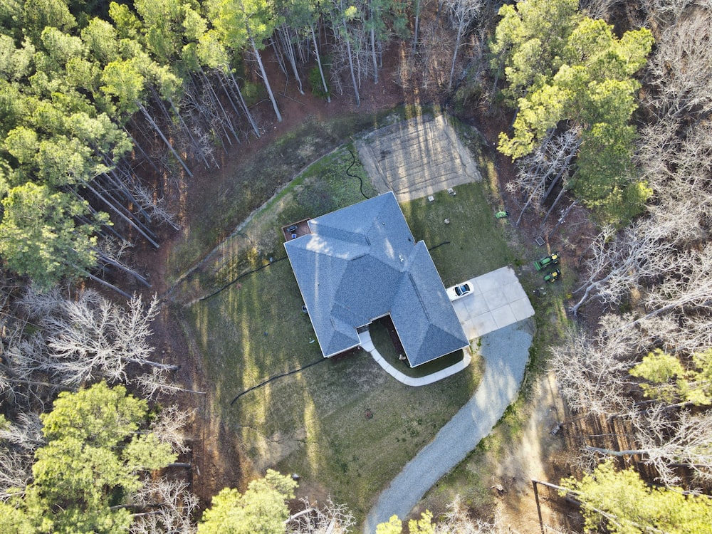 an aerial view of a house in the woods