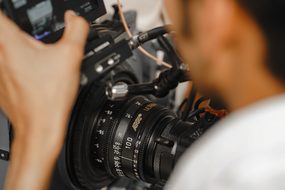 a man holding a camera up to take a picture