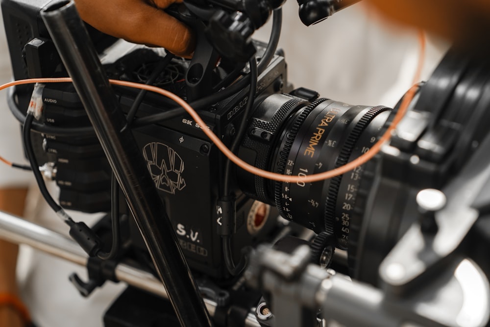 a close up of a camera with a hand on it