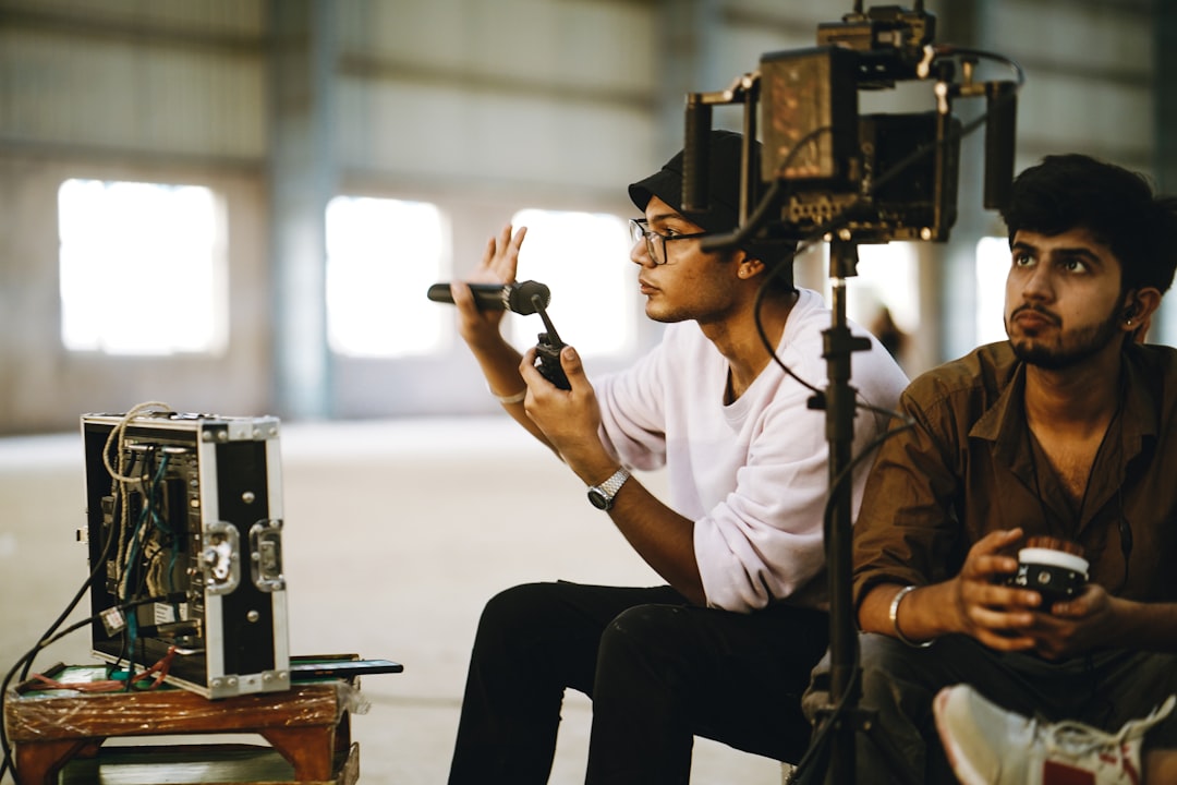 a couple of men sitting next to each other, Music Video Production