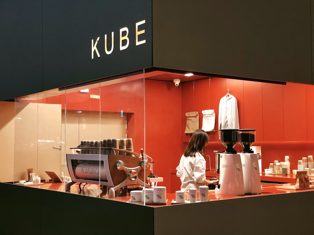 a woman standing in front of a store window