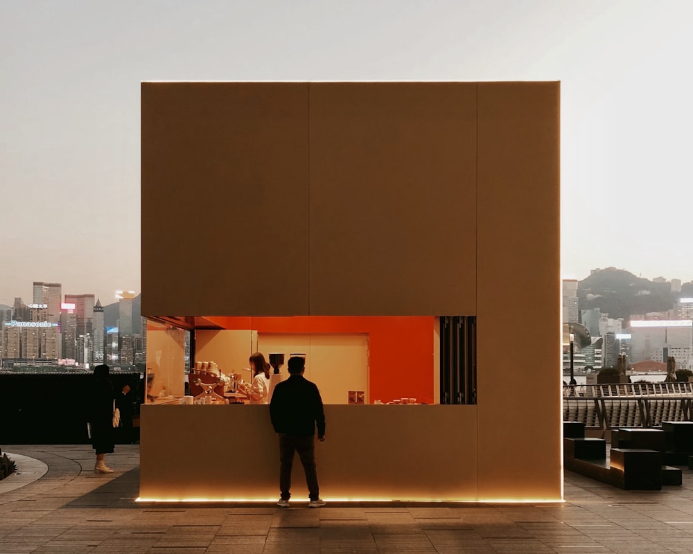 a man standing in front of a tall building