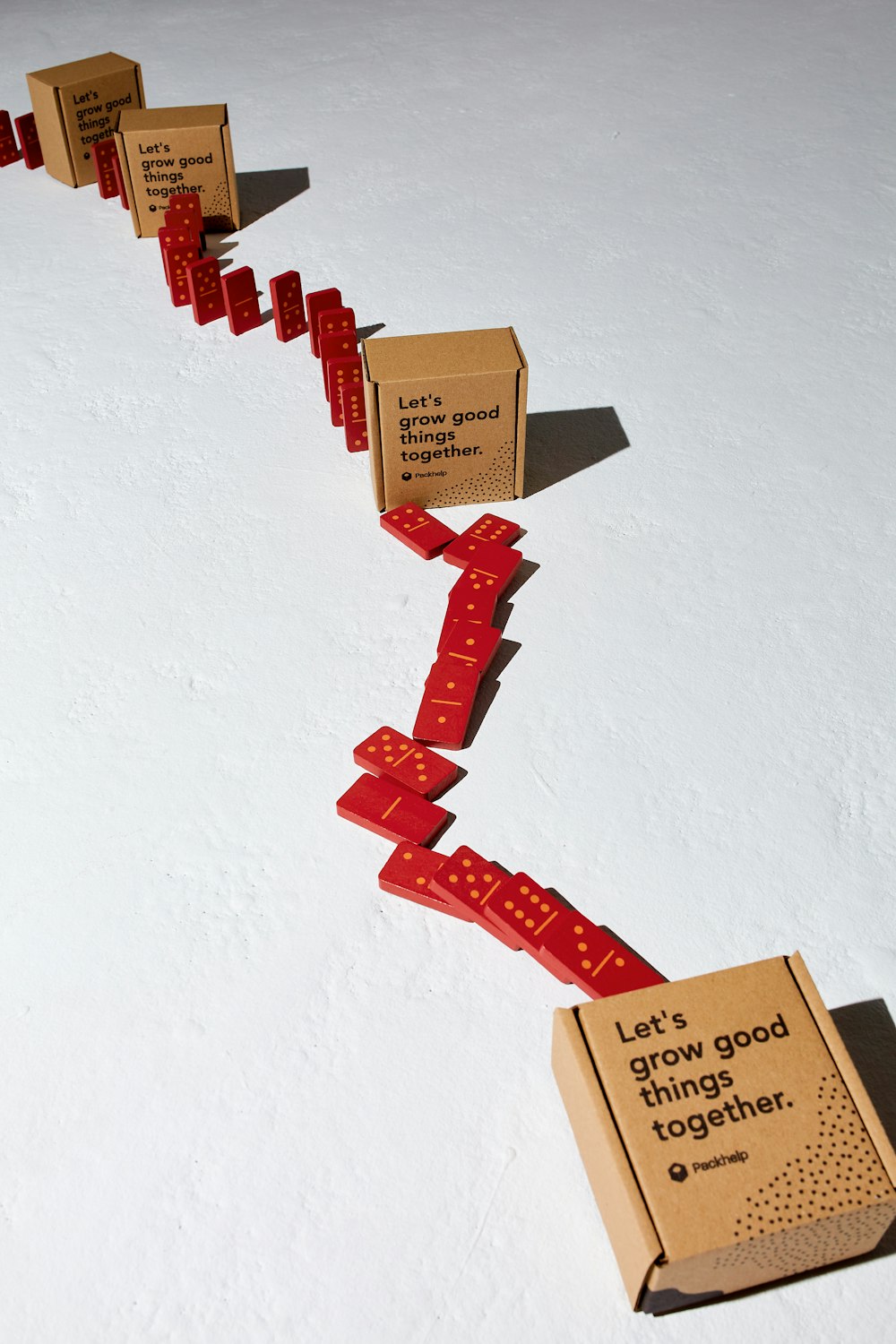 a long line of boxes with red ribbons attached to them