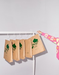 a woman holding a paper bag on a clothes line