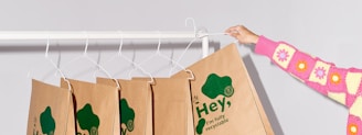 a woman holding a paper bag on a clothes line