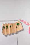 A happy customer holding a green bags package outside a cozy café, showcasing the brand’s commitment to sustainability.