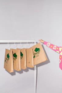 a woman holding a paper bag on a clothes line
