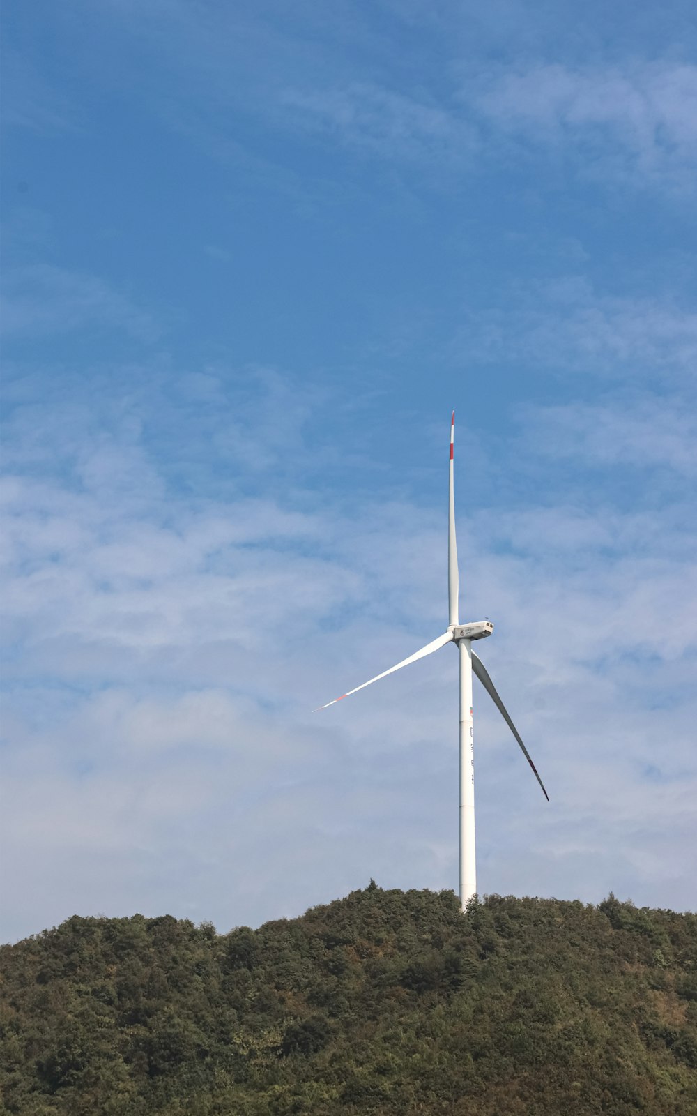 a wind turbine on top of a hill