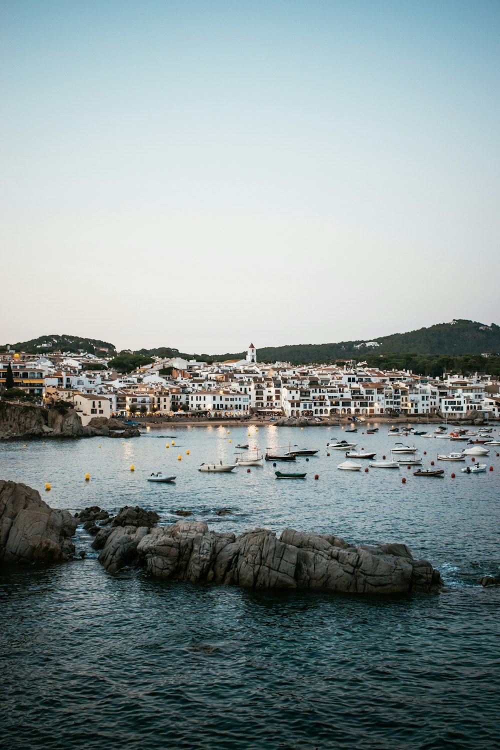 a harbor filled with lots of boats on top of a body of water