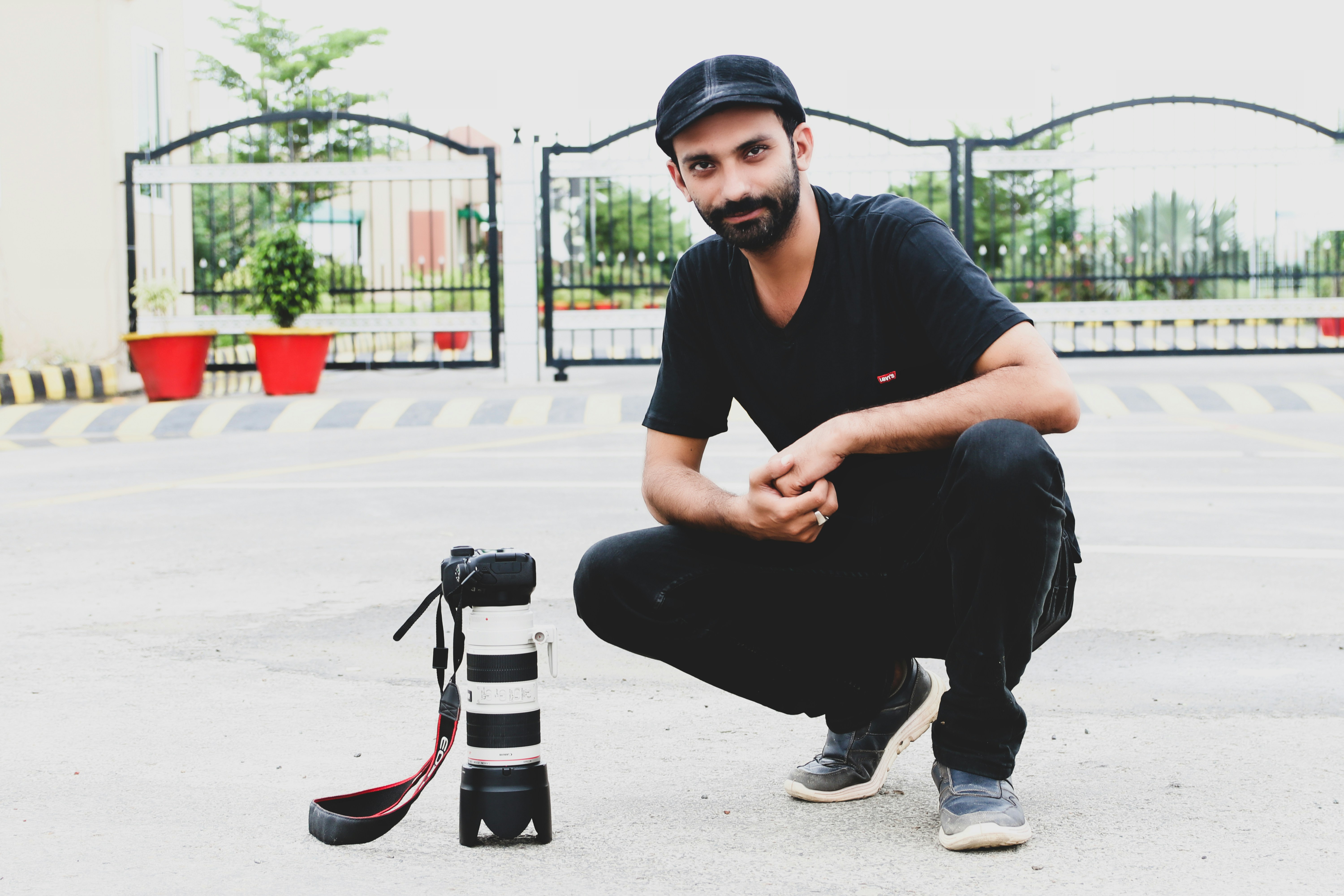 a man kneeling down next to a camera