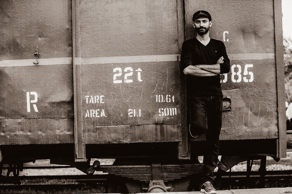 a man standing in front of a train car