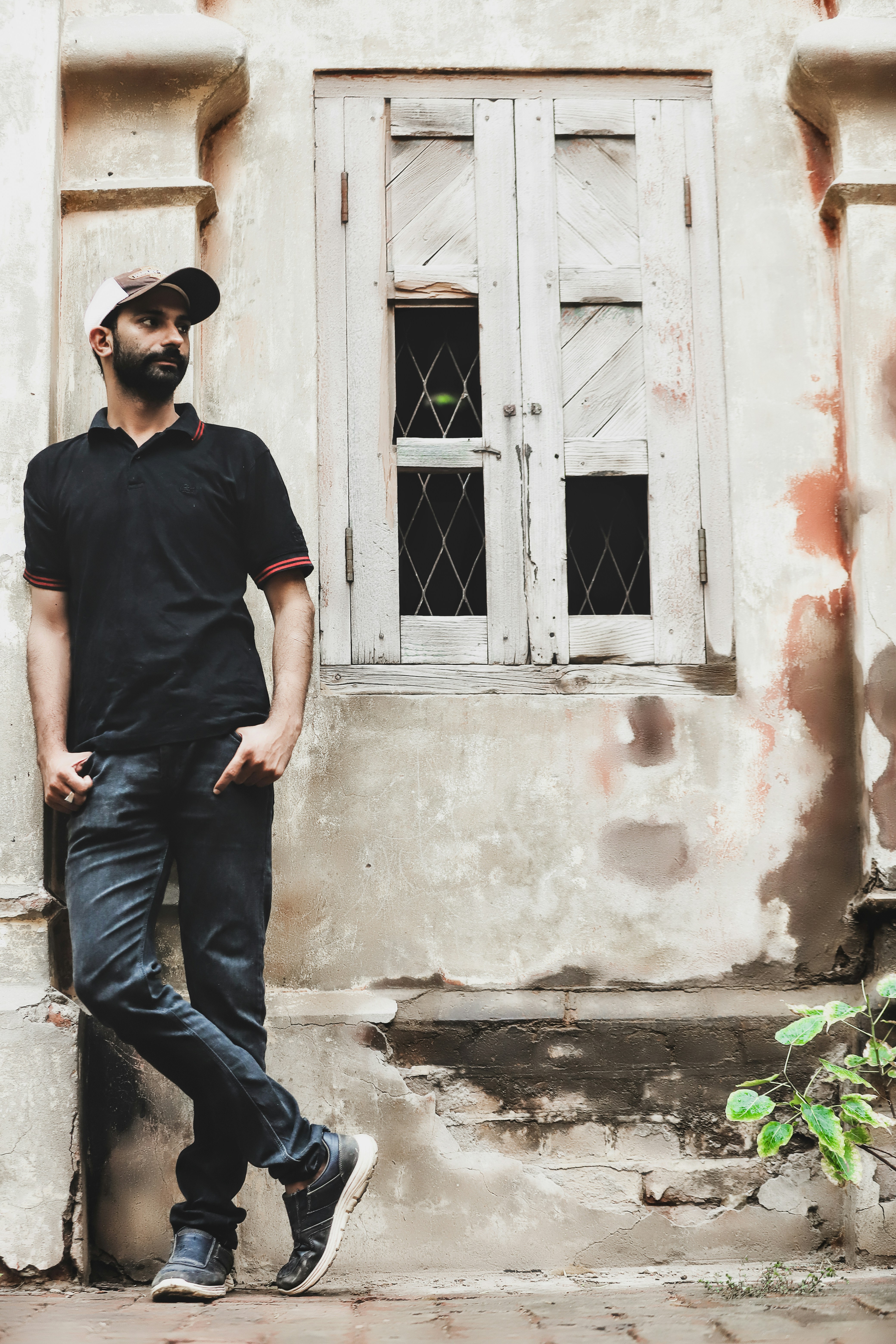a man standing in front of a white building